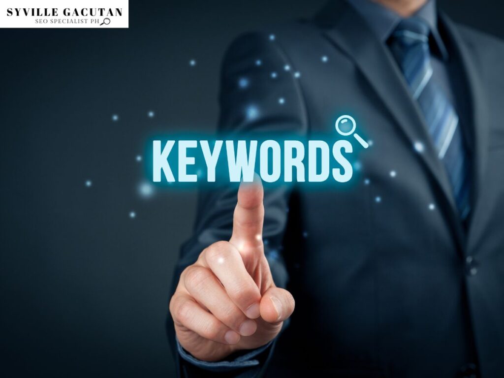 A man in suit touching the word "KEYWORDS" in a dark background.