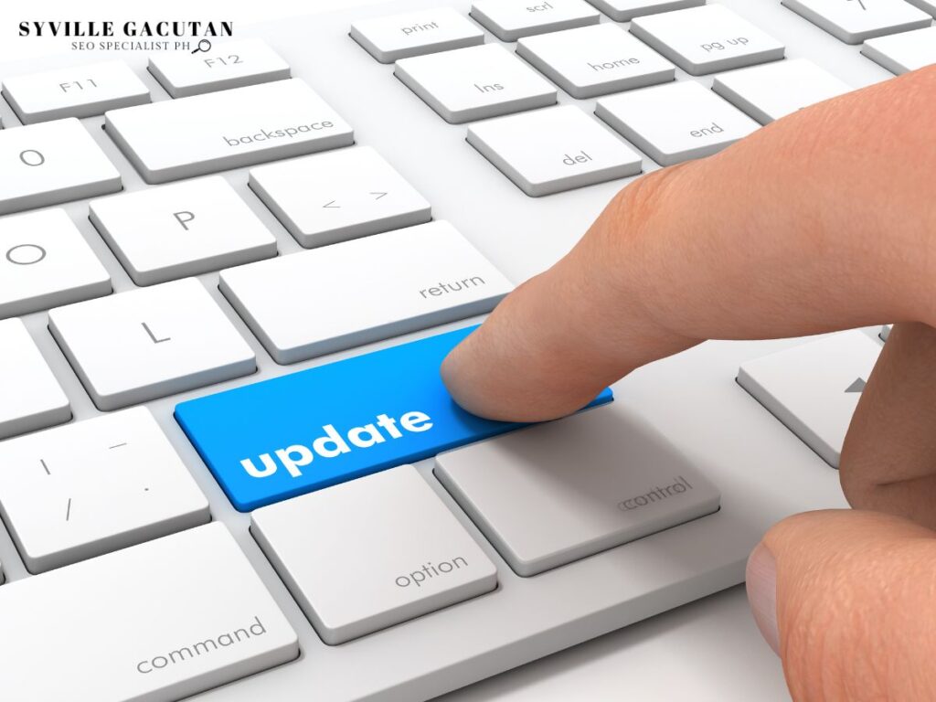 A finger pressing a keyborad key with the word"Update"