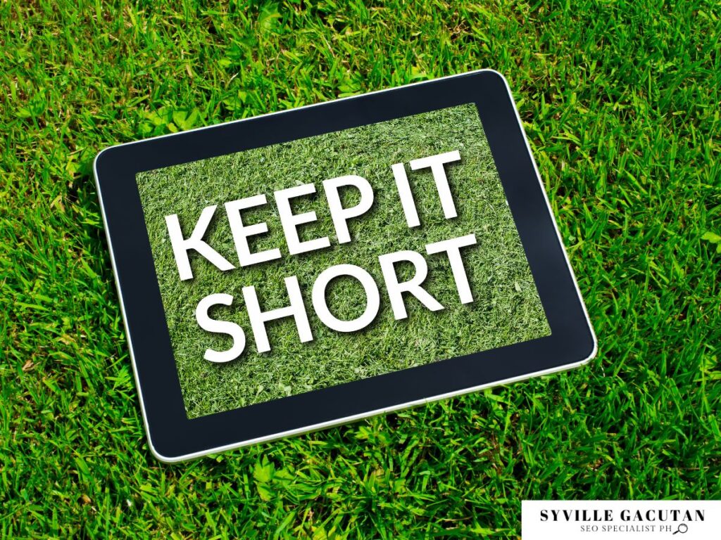 A tablet on the grass displaying the word "KEEP IT SHORT" 