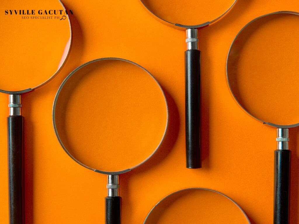 Magnifying glasses on an orange background.