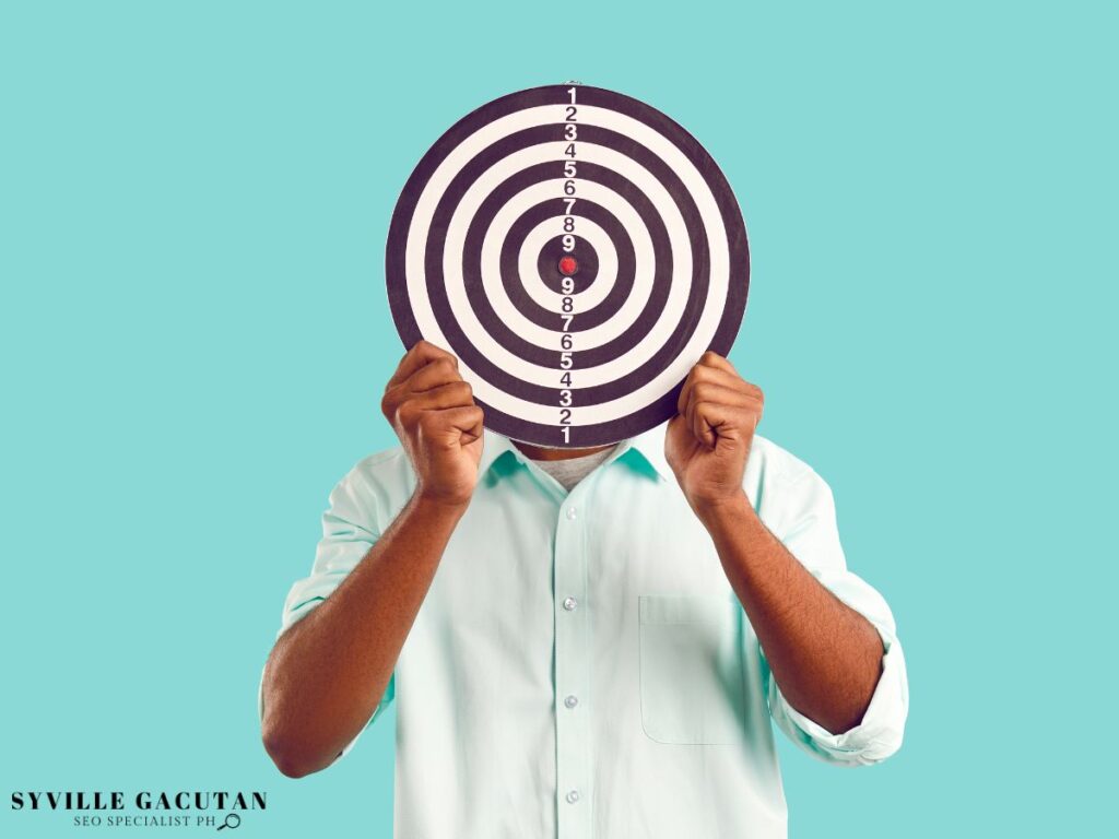 A man holding a target in front of his face.