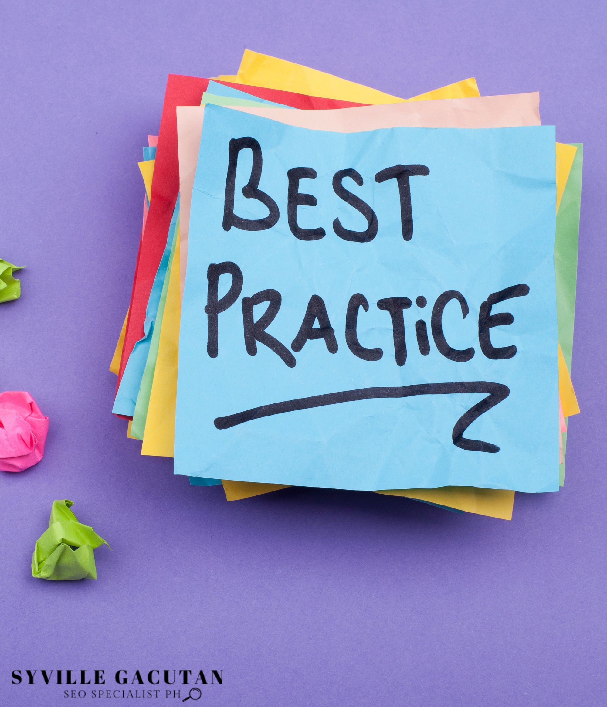 "BEST PRACTICE" note on stacked colorful papers.