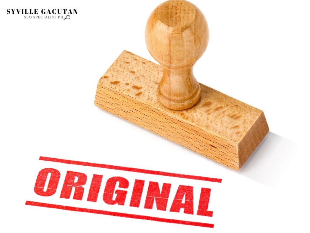 Wooden stamp with "ORIGINAL" stamped in red on a white background.