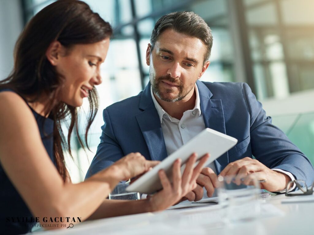 Business colleagues discussing on a tablet.