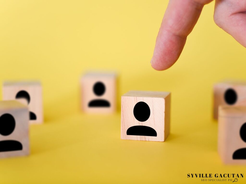 A hand picking up a wooden blocks with a user profile icon.