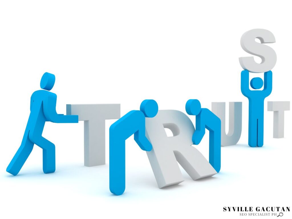 A group of blue human figure building the word "TRUST"