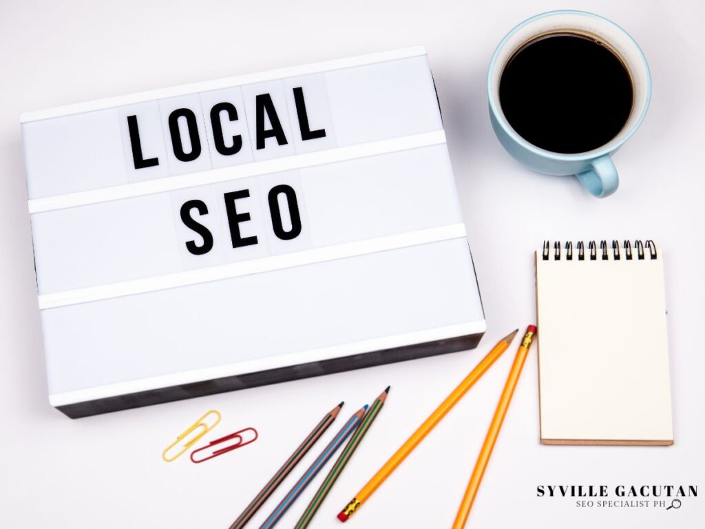 Lightbox reading "Local SEO" with office supplies and coffee.