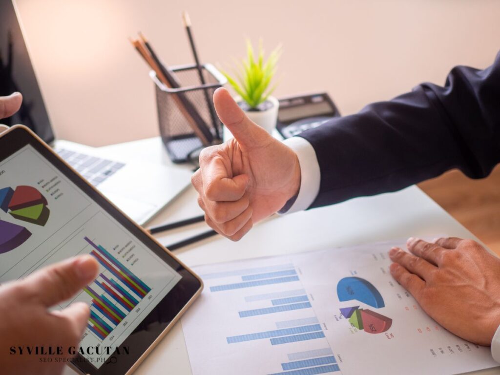 Thumbs up given to tablet showing colorful charts.