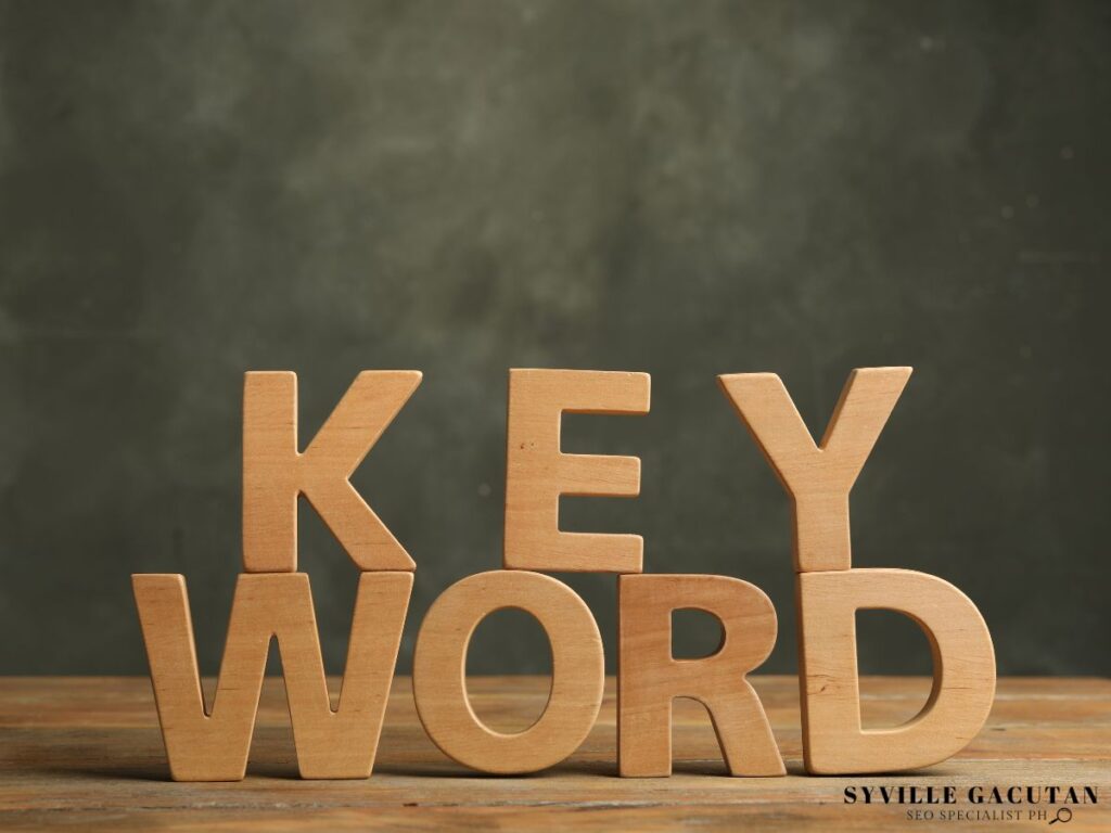 The word "KEYWORD" made of wooden letters, placed on a wooden surface.