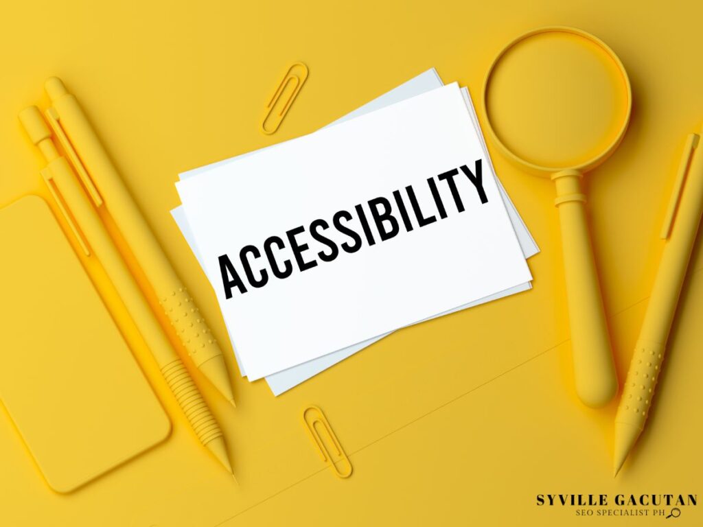 The word "ACCESSIBILITY" written on a papaer with a yellow magnifying glass, pen, and paper clip.