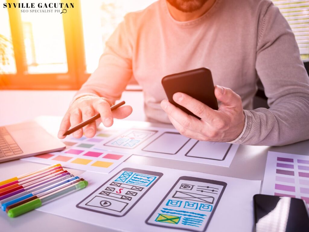 Designer planning layouts with smartphone.