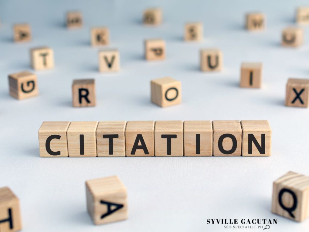 A wooden blocks spelled "CITATIONS" with random block in the background.