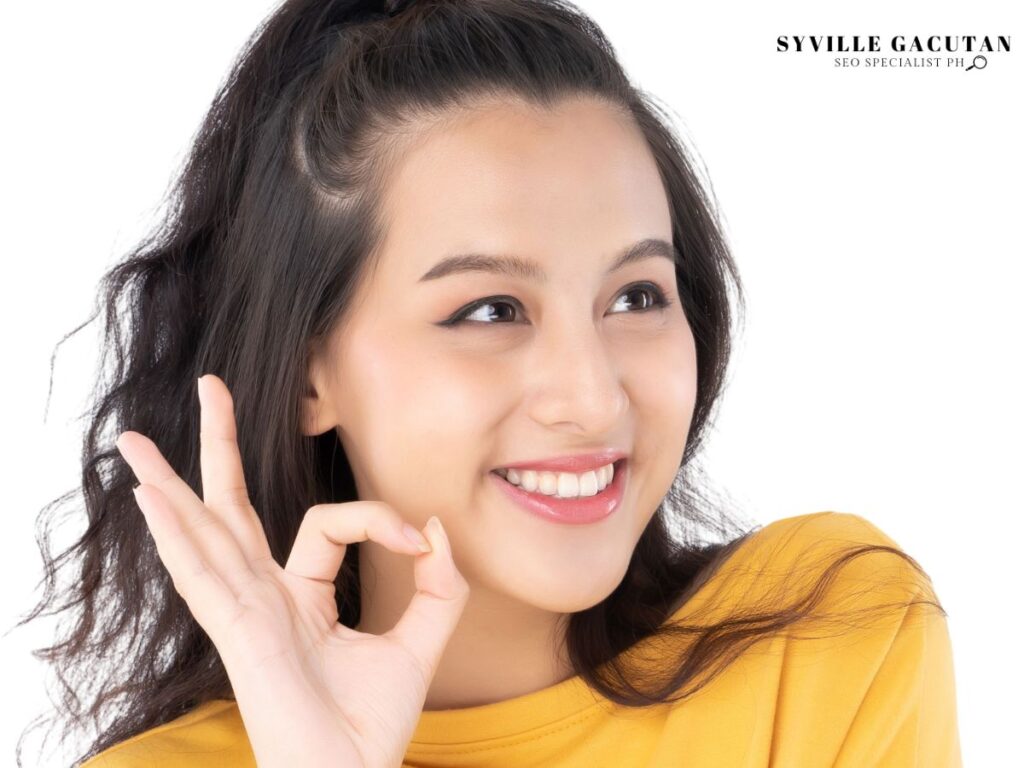 A woman showing okay gesture on white background.