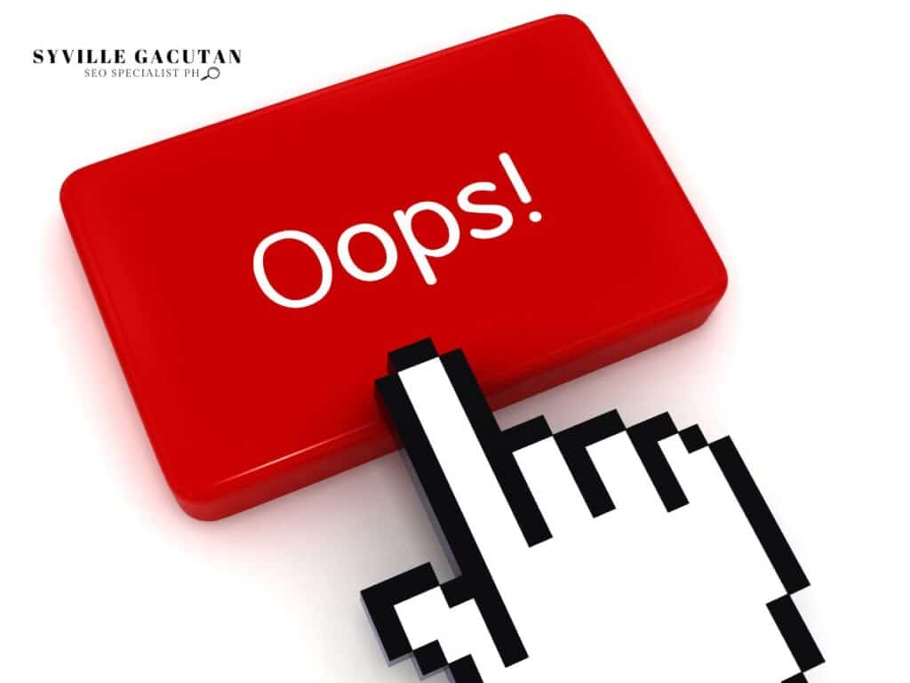 A red button with "Oops!" and a pixelated hand cursor pointing at it.