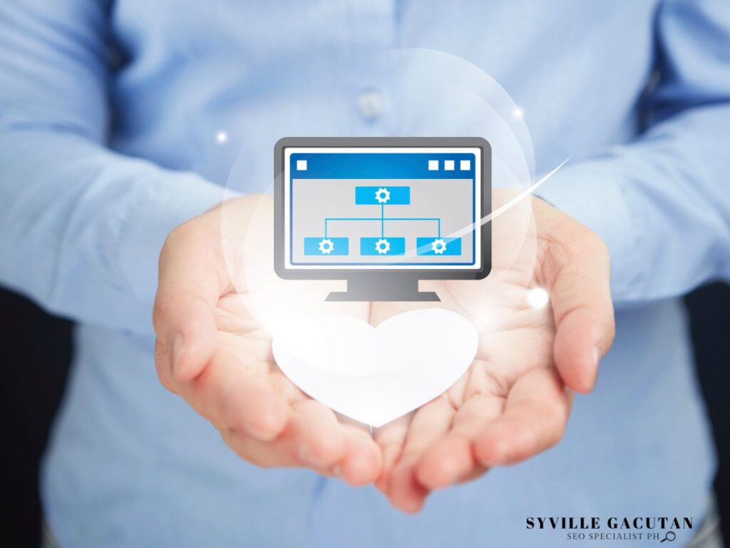 A person holds out their hands, showcasing a computer icon with a heart.