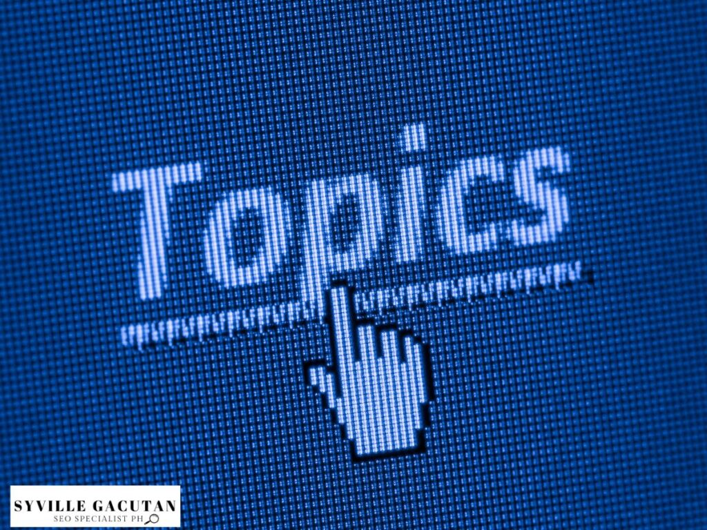 The word "Topics" on a pixelated blue screen with a hand cursor icon.