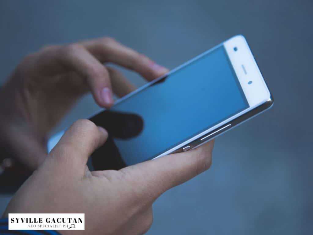 Close-up of hands using a smartphone, showing engagement with mobile devices.