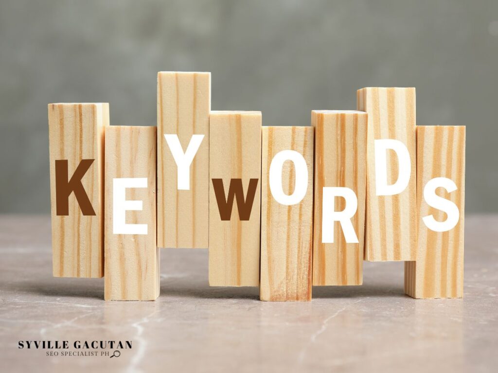 Wooden blocks spelling "KEYWORDS" on a table.