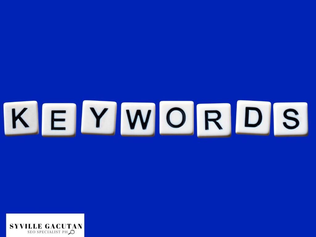 The word "KEYWORDS" is spelled out with letter tiles on a blue background.