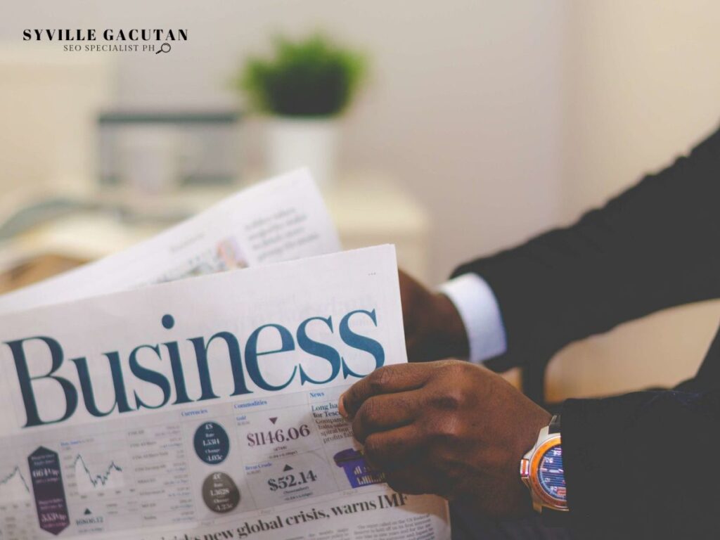 A close up of a man in a suit reading a newspaper with the word "Business"