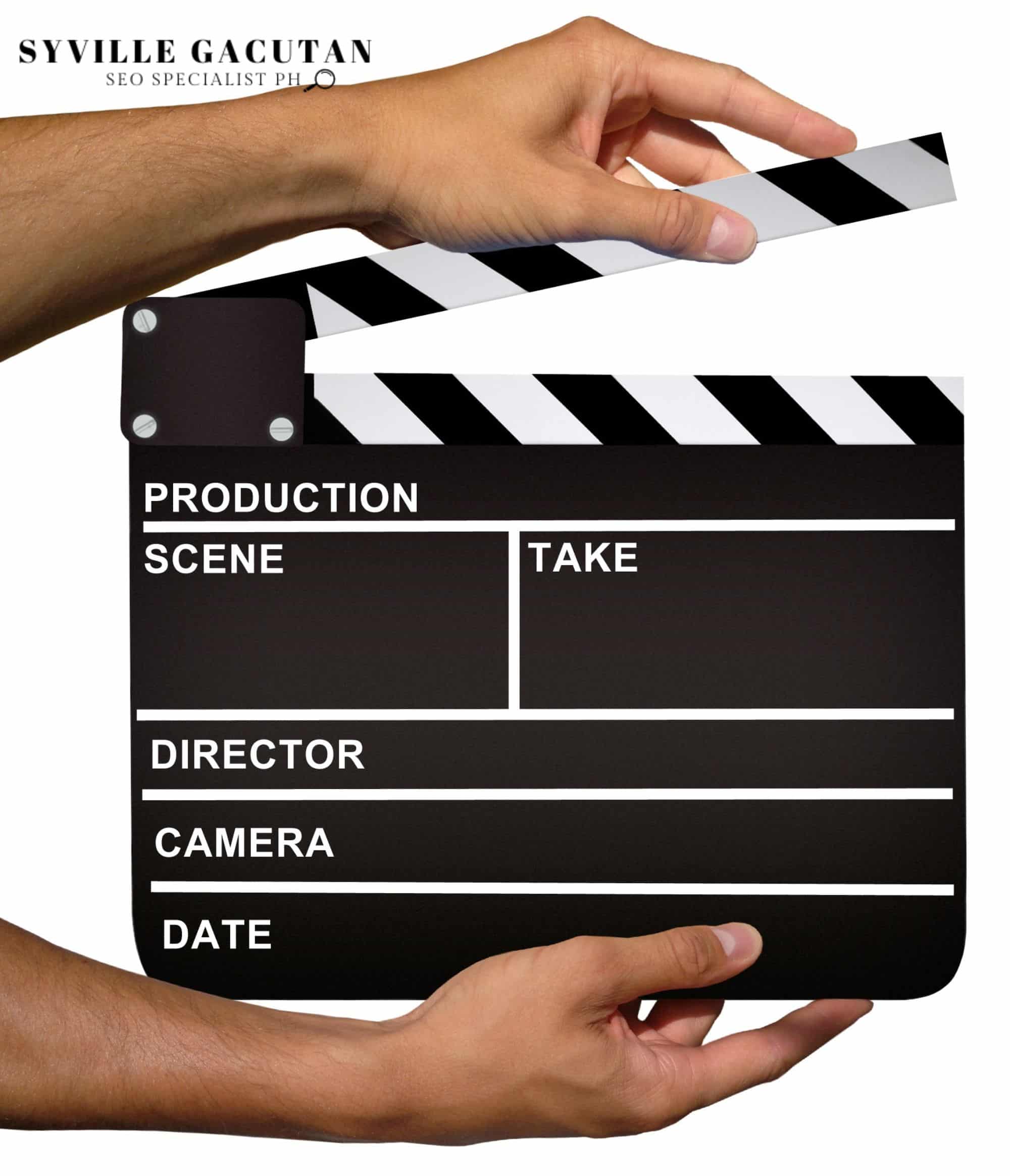 A movie clapperboard held by two hands.