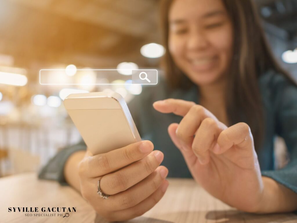 A woman about to press her phone with a search bar above it.