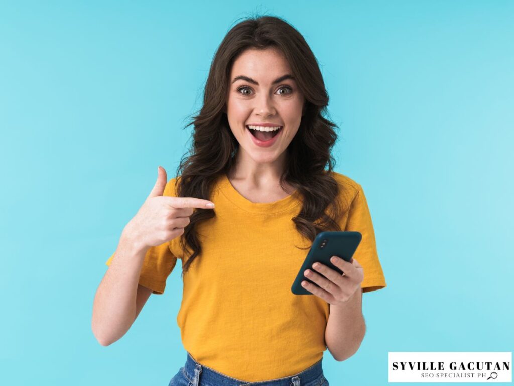 A woman pointing her phone with an energetic expression.