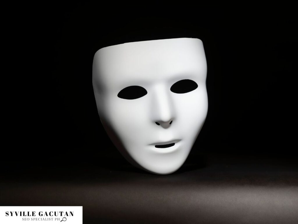 A white, expressionless mask floating against a dark background.