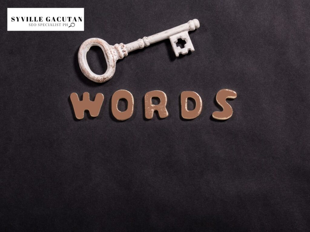 A white vintage key with the word "WORDS" on a black background.