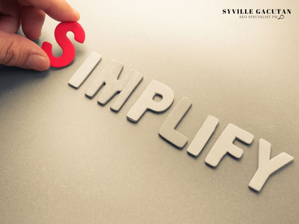 Hand placing a red "S" to complete the word "SIMPLIFY."

