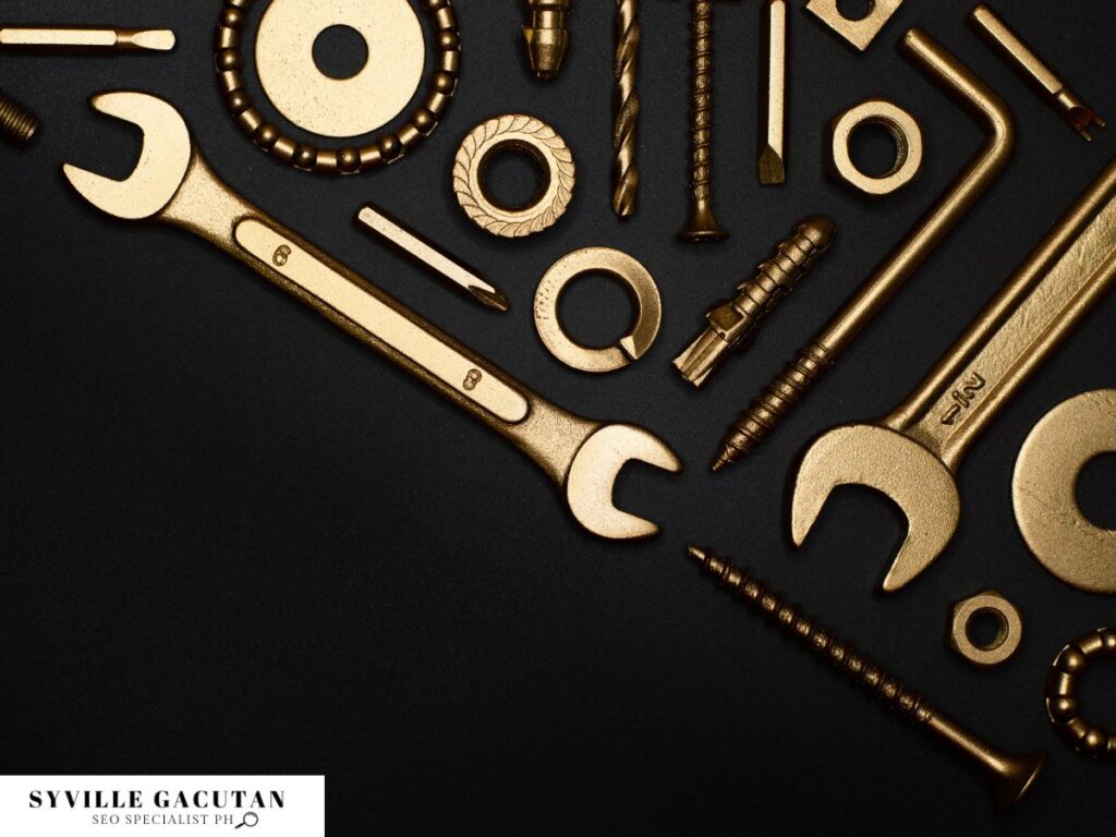 Assorted golden tools on a black background.