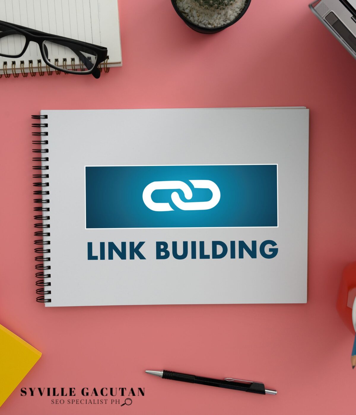 A digital icon of link and text "LINK BUILDING" on the notebook.