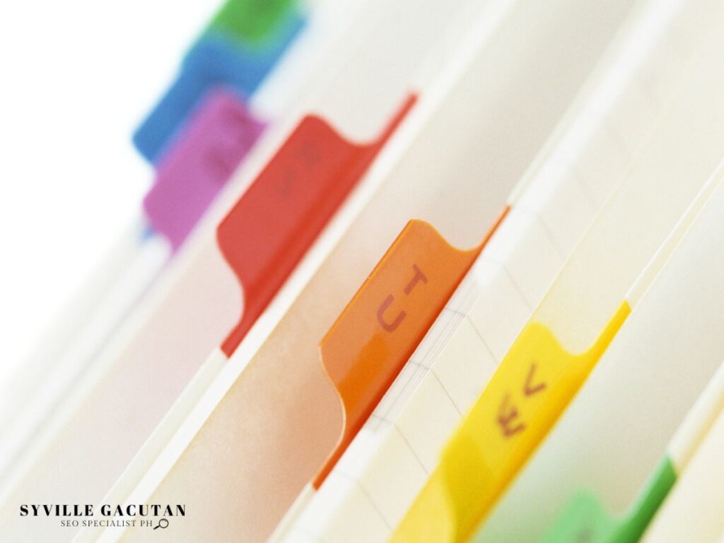 A close-up shot of a file folder with colorful tabs.