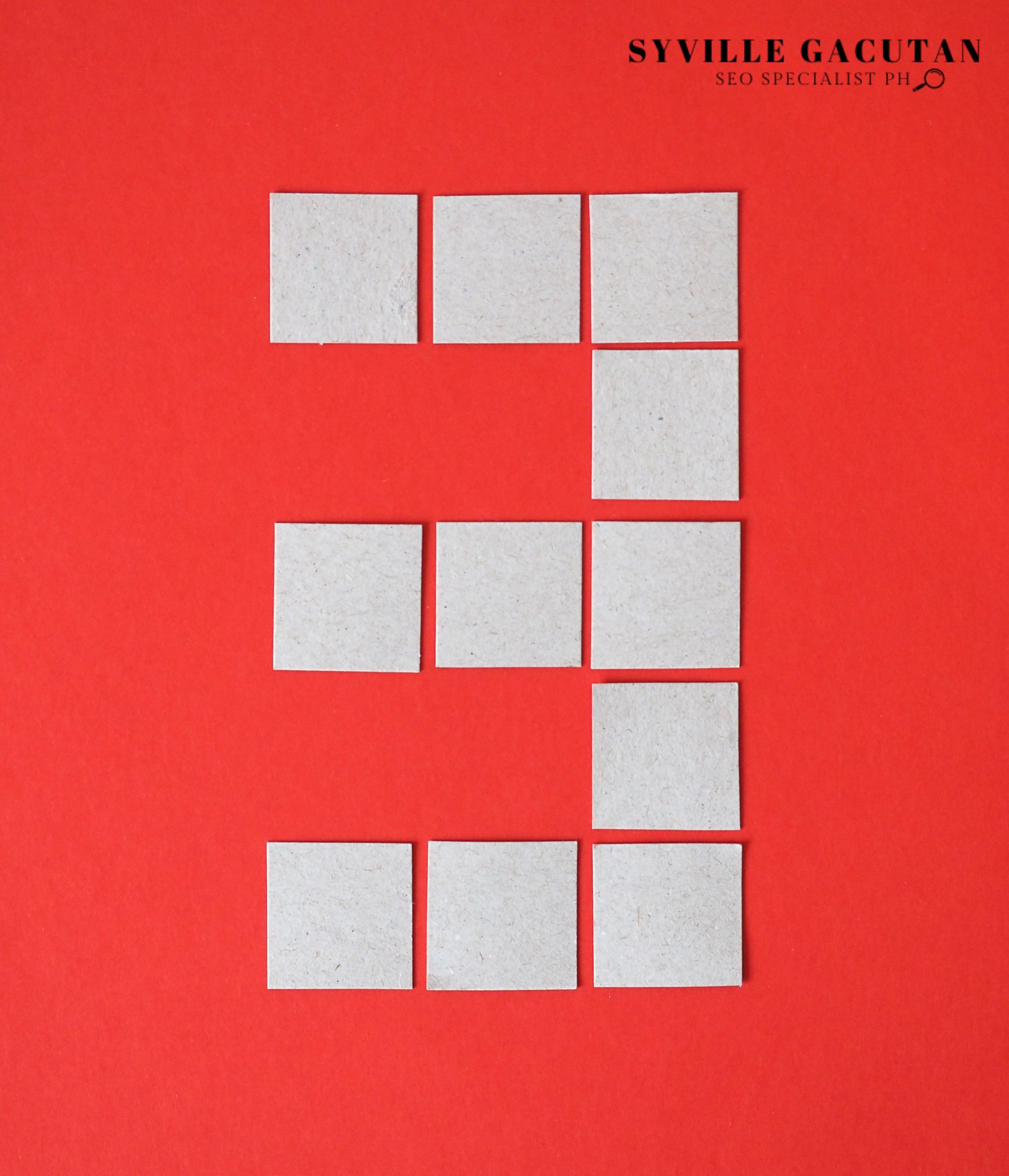White squares arranged forming number 3 on vibrant red background.