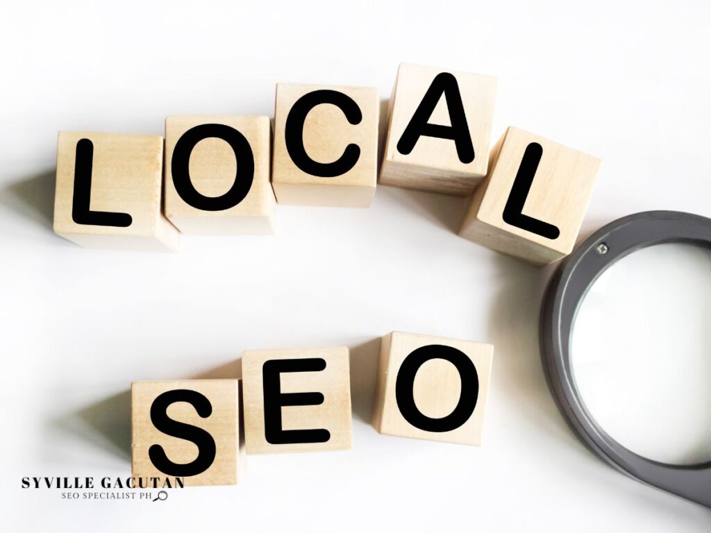 Wooden blocks spelling 'LOCAL SEO' with magnifying glass.