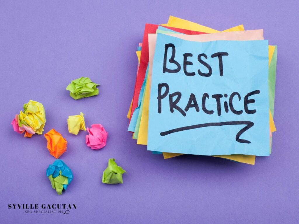 "Best Practice" written on blue sticky note with colorful crumpled paper balls on purple background.