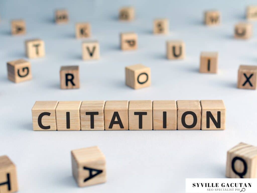 Wooden blocks spelling "CITATION" with scattered letter blocks around.