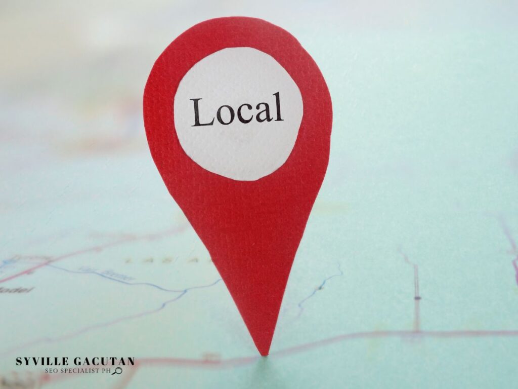 Red map pin labeled "Local" placed on a blurred map background.