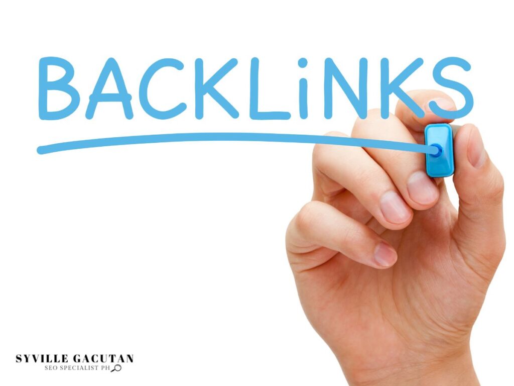 Hand writing "BACKLINKS" in blue marker with white background.