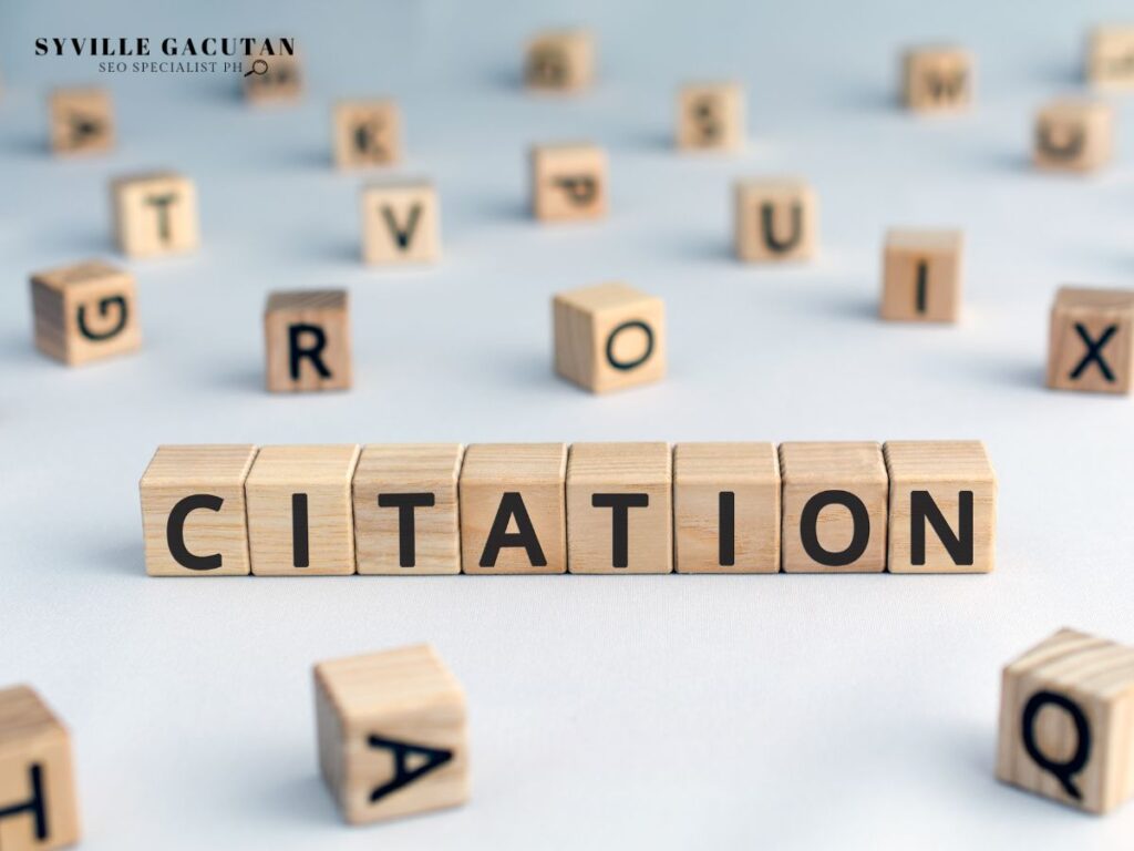 Wooden blocks spelling "CITATION" surrounded by scattered letter blocks on a light background.