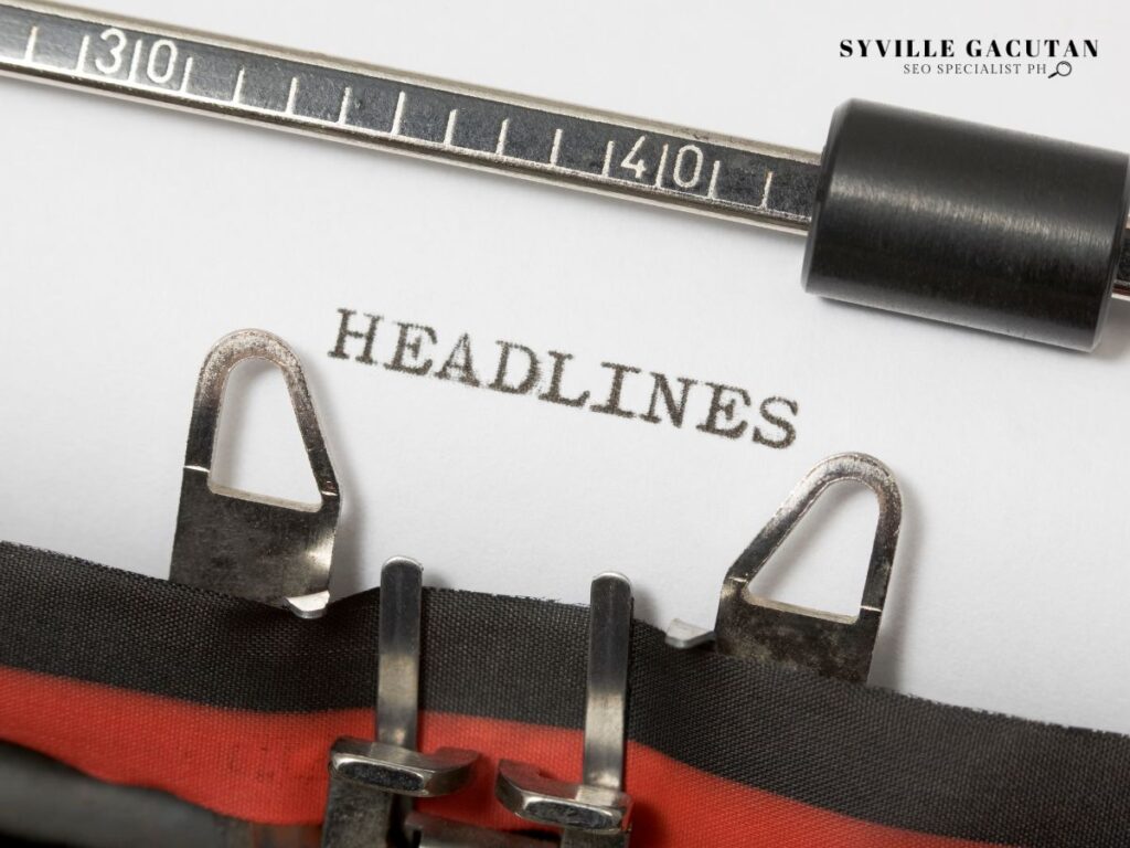 Close-up of a typewriter with "HEADLINES" typed on white paper, showing measurement markings above.