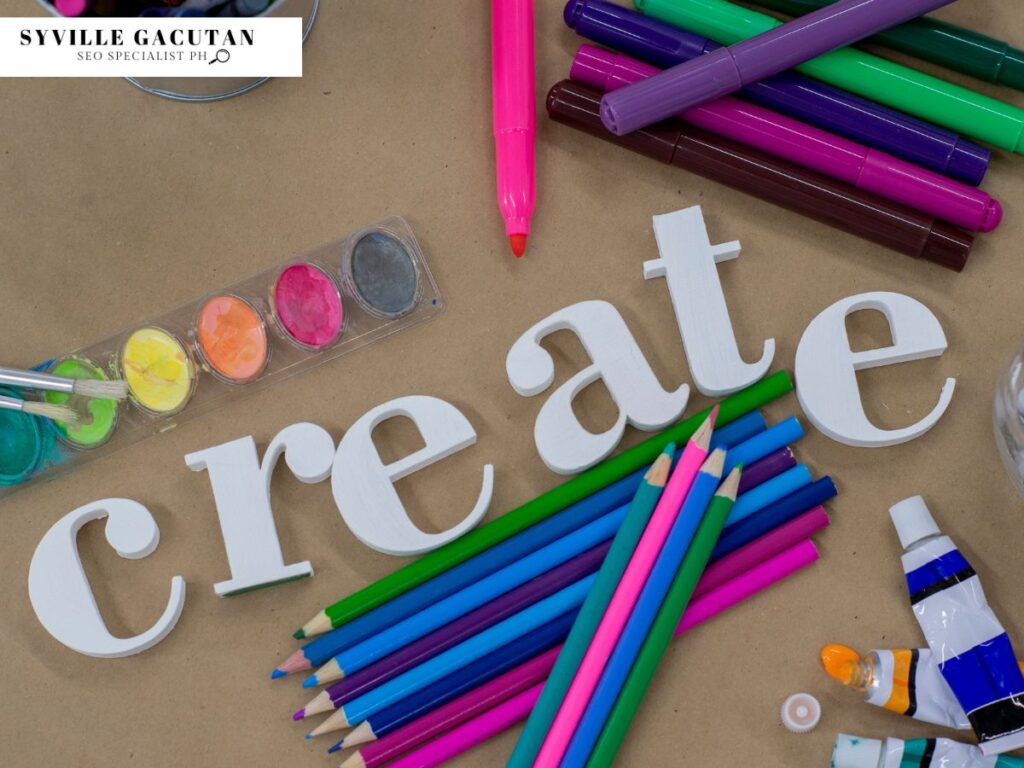 Art supplies and colored pencils around the word "create."