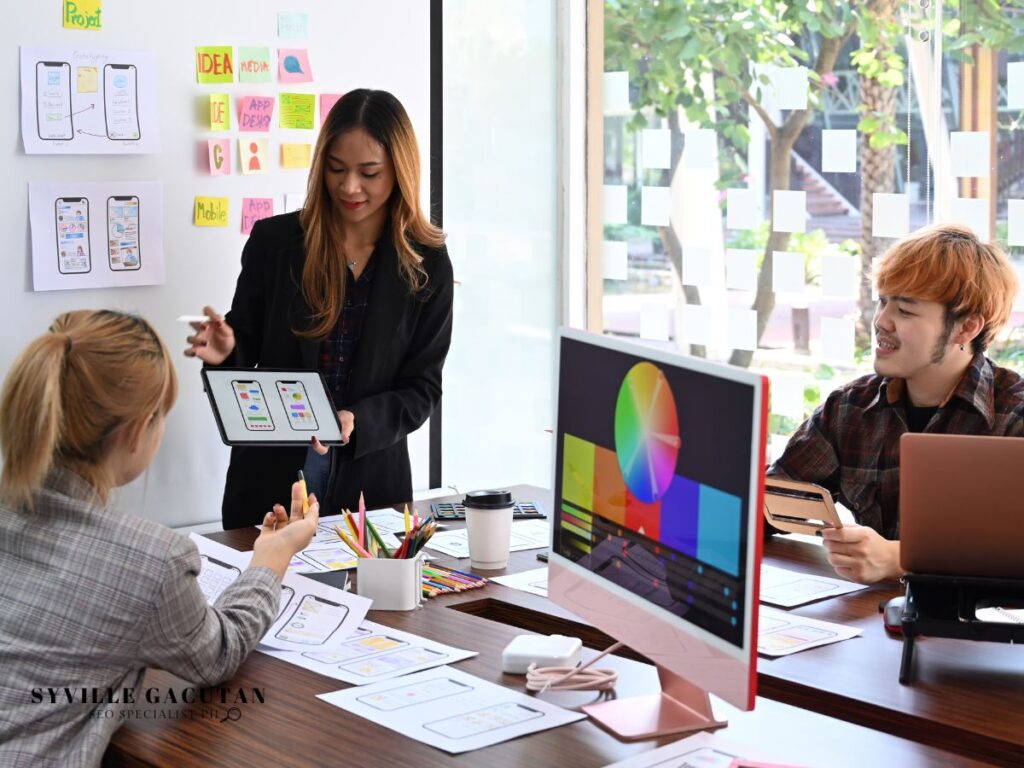 Creative team discussing app designs with colorful post-its and sketches.