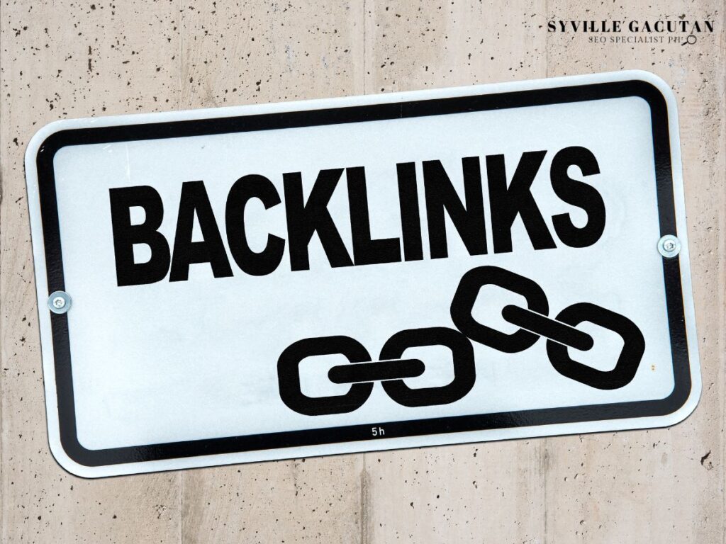 White sign with "BACKLINKS" text and chain link icon on textured wall.