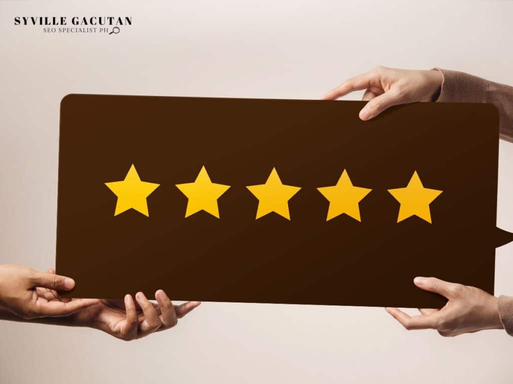 Two hands holding a board with five yellow stars, indicating a high rating.