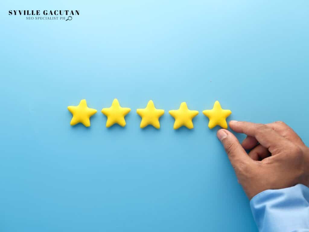 Hand placing the fifth yellow star on a row of stars.