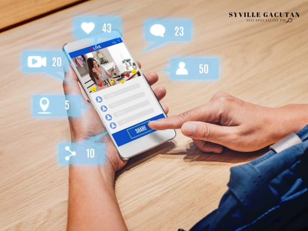 Hand holding phone with social media engagement icons floating around the screen.