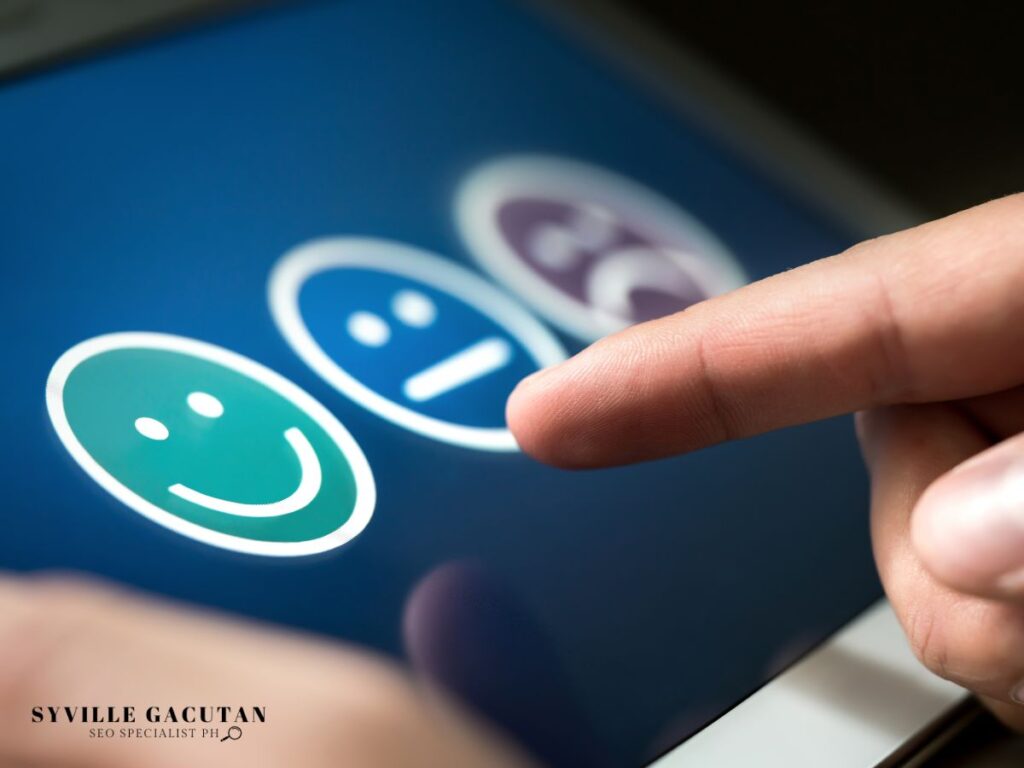 Finger selecting from three emoji feedback icons on blue digital interface.