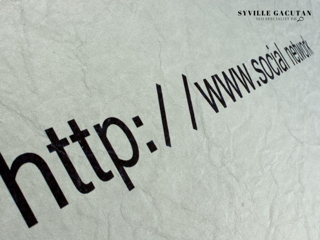 Close-up of "http://www.social" text printed in black on textured gray paper.