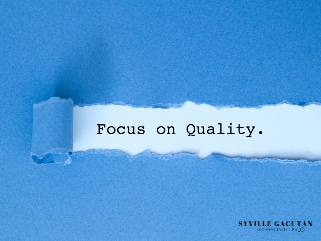 "Focus on Quality" text revealed through torn blue paper.
